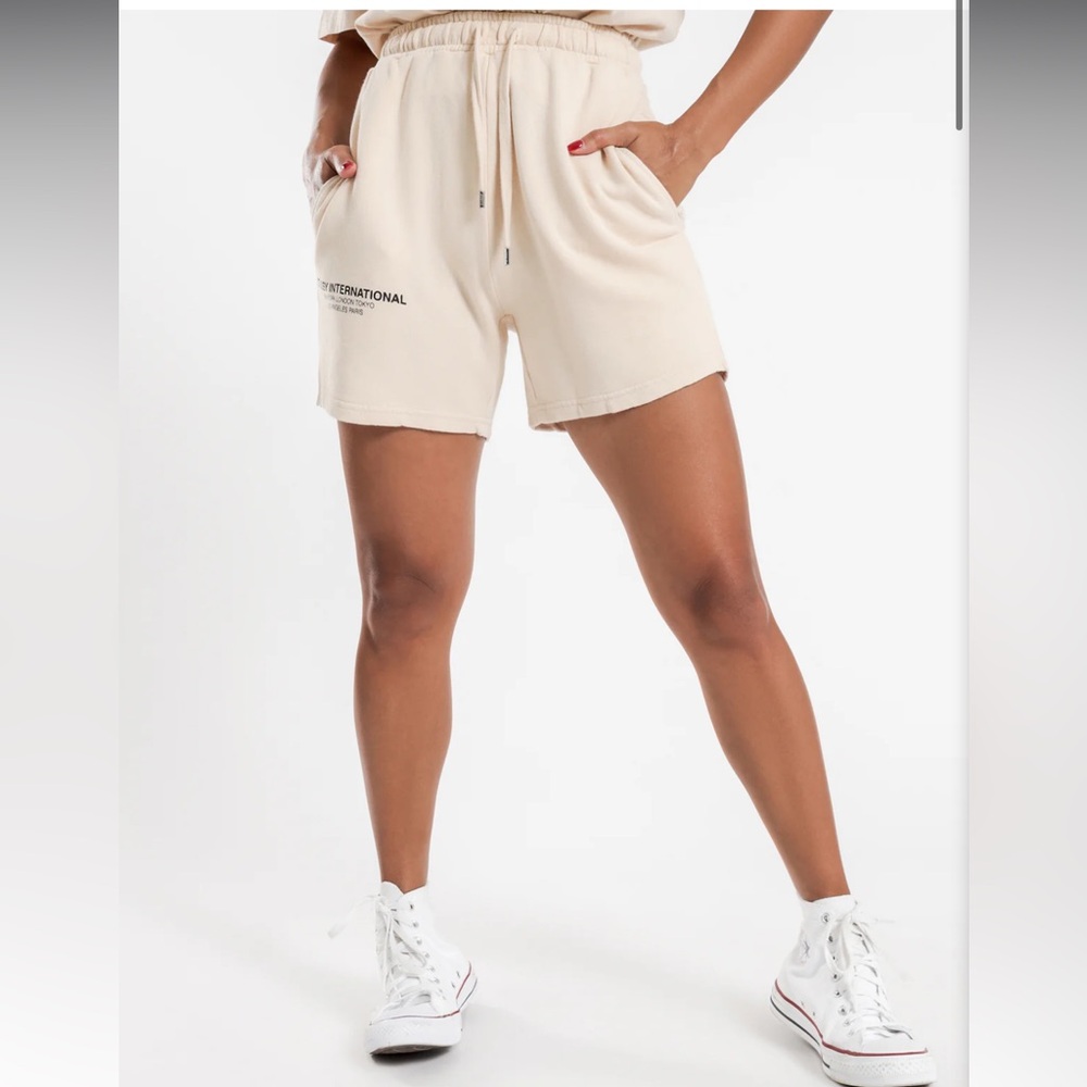 stussy low waisted shorts in white sand size 12